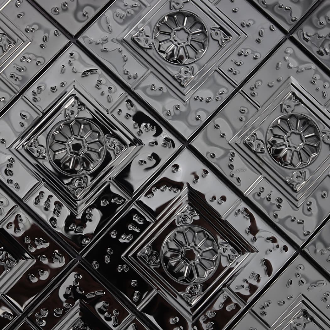 Detailed texture of raised square patterns on black metal mosaic tiles