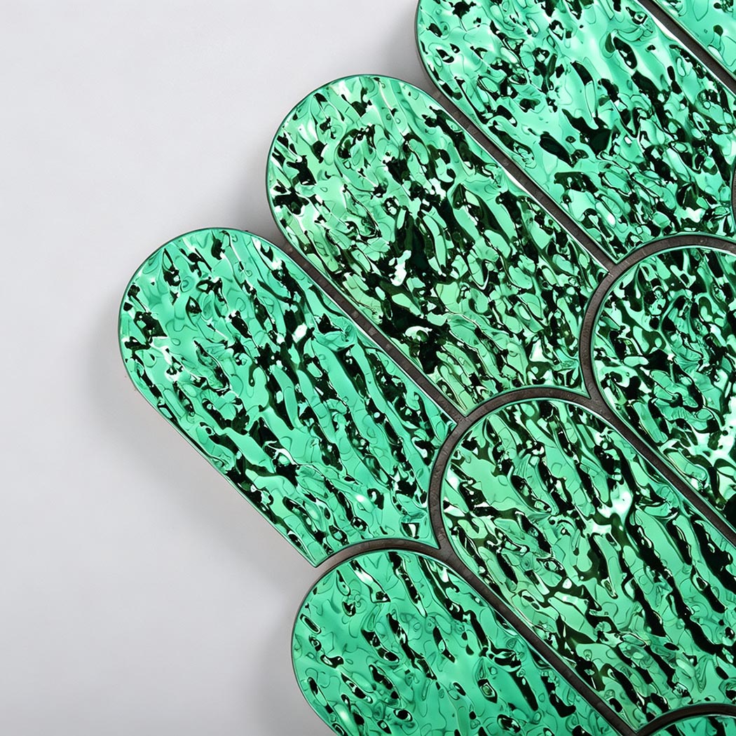 Close-up of emerald green glossy ripple scallop metal tile texture