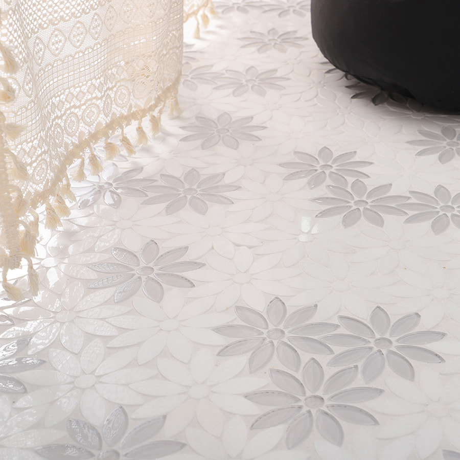 White flower mosaic floor beside lace curtain