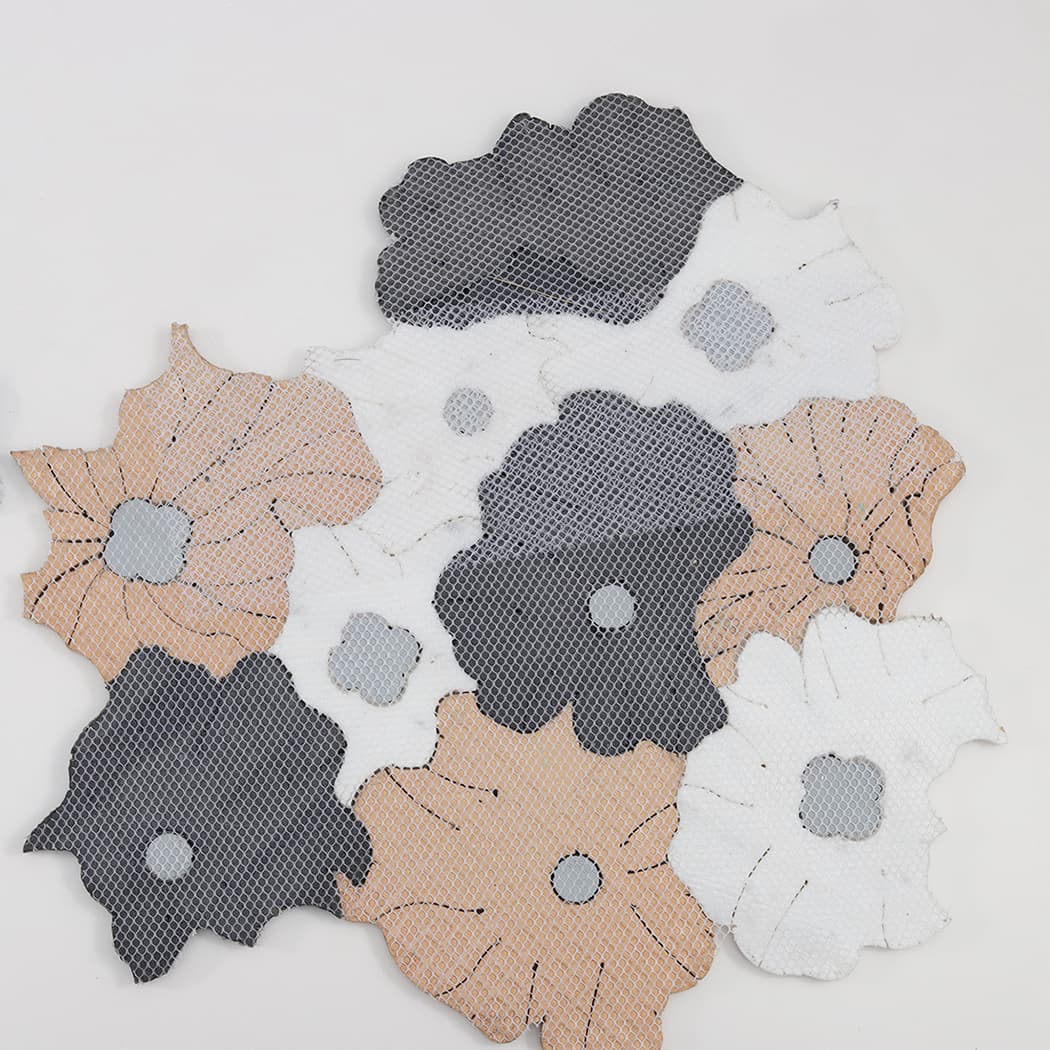 Back side of flower shaped mosaic wall art showing mesh backing
