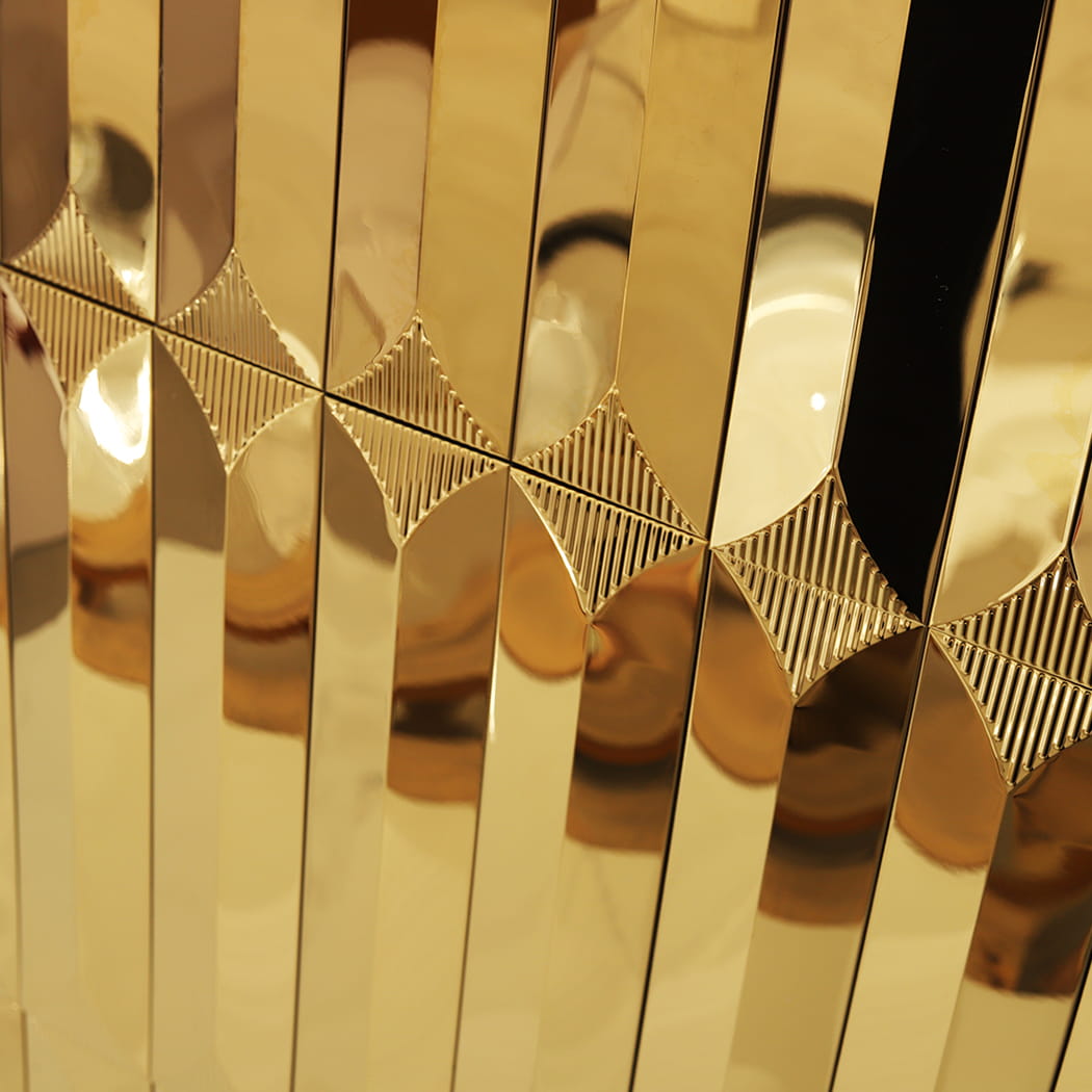Close-up of the geometric diamond pattern formed by gold 3D metal mosaic tiles.