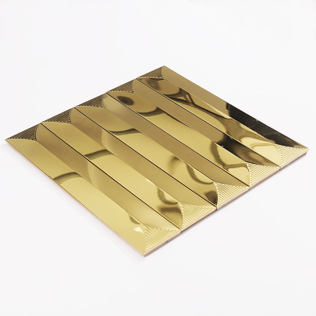 A single gold 3D linear metal mosaic tile sheet lying flat on a white surface.