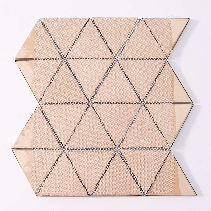 Back view of a gold metal mosaic tile panel showing the mesh mounting system.