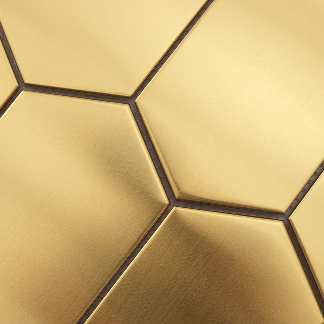 Close up of seam joint detail on gold brushed elongated hexagon mosaic tile