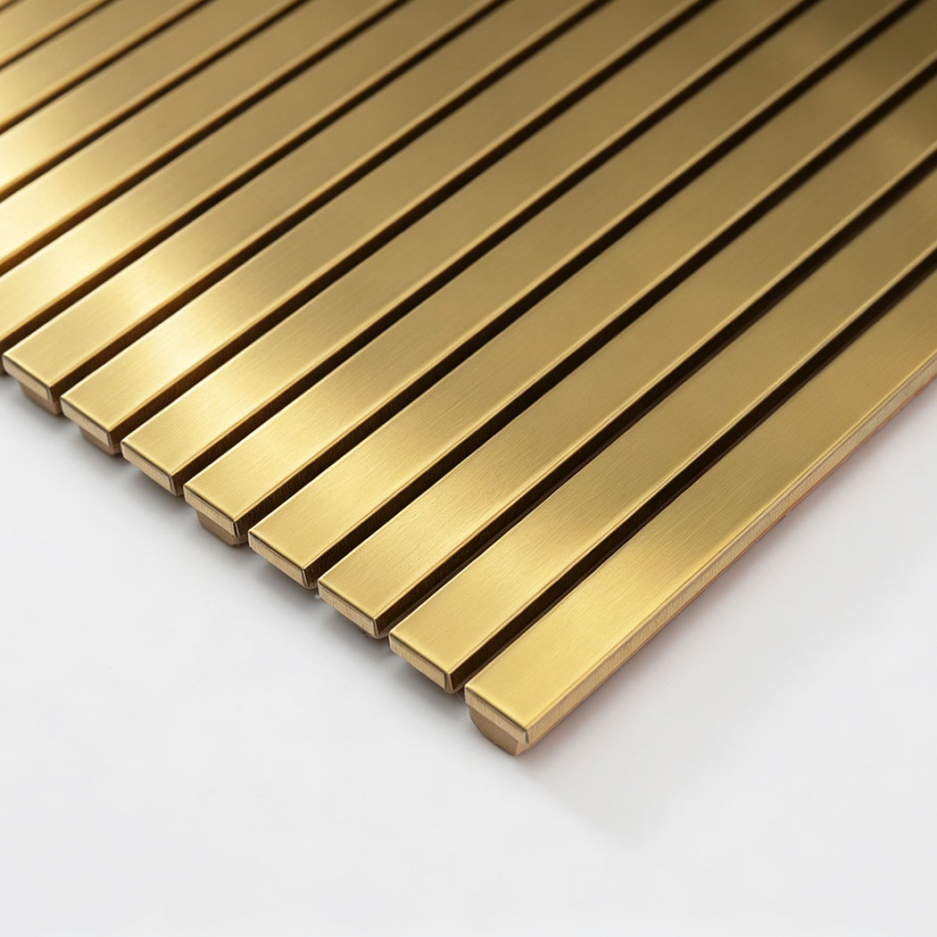 Edge detail of gold brushed stainless steel linear tile sheet