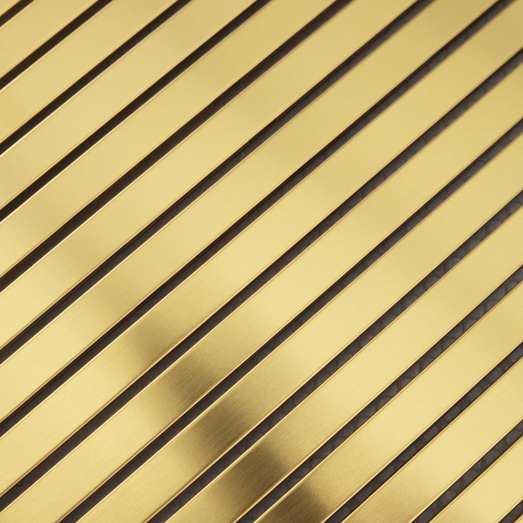 Close-up of gold brushed stainless steel linear tile strips