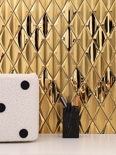 Gold diamond-shaped stainless steel mosaic tiles with a glossy finish. 