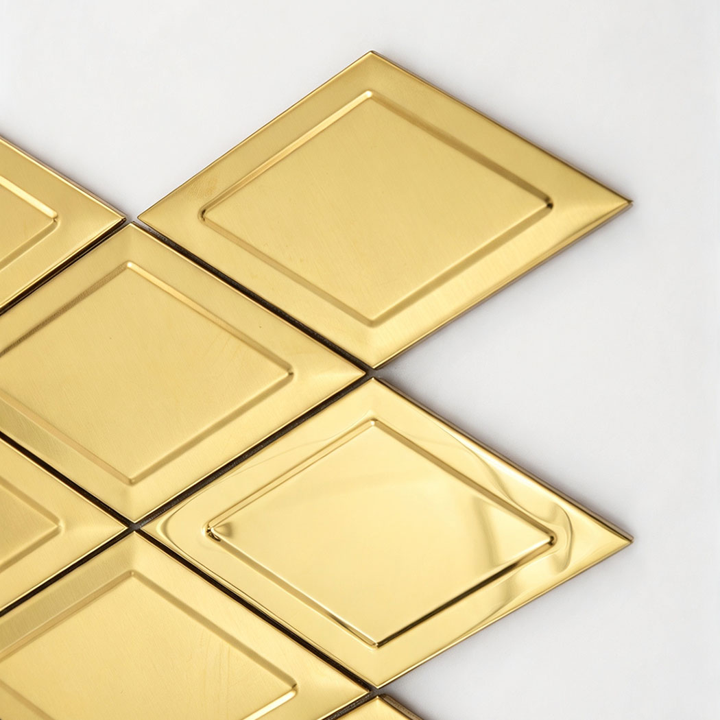 Close up of gold diamond stainless steel mosaic tiles with raised geometric detail