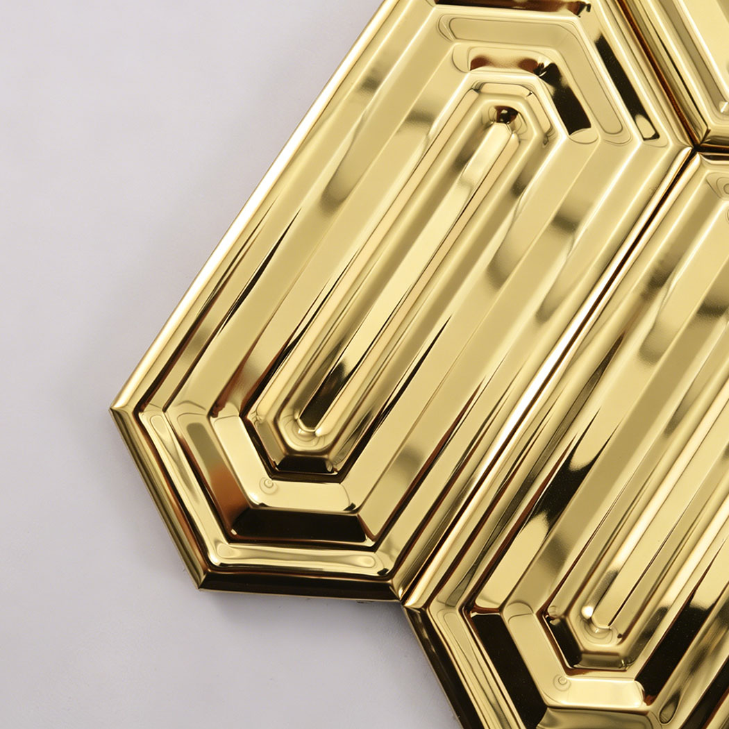Close up of gold reflective elongated hexagon mosaic tiles showing metallic surface