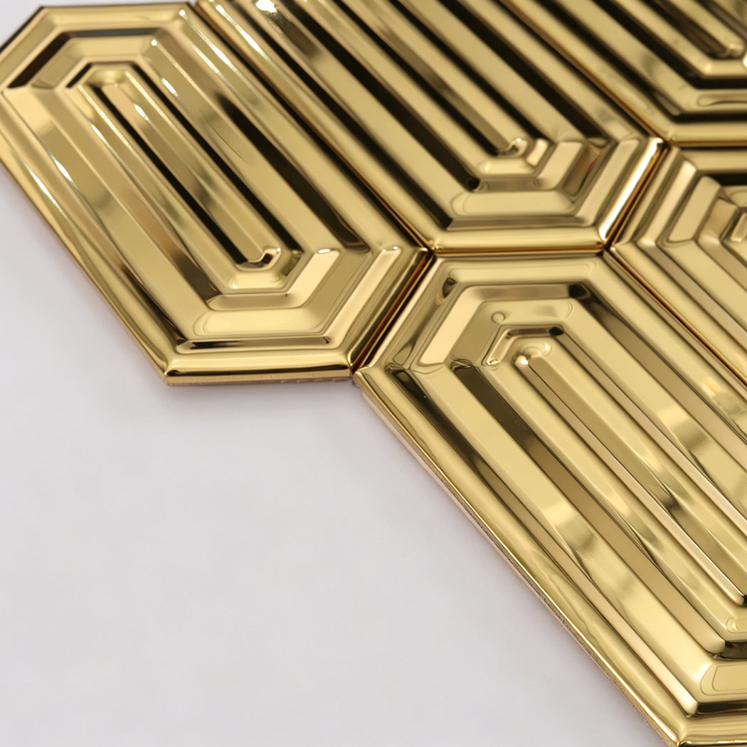 Angled close up of gold elongated hexagon tile showing edge shine and depth