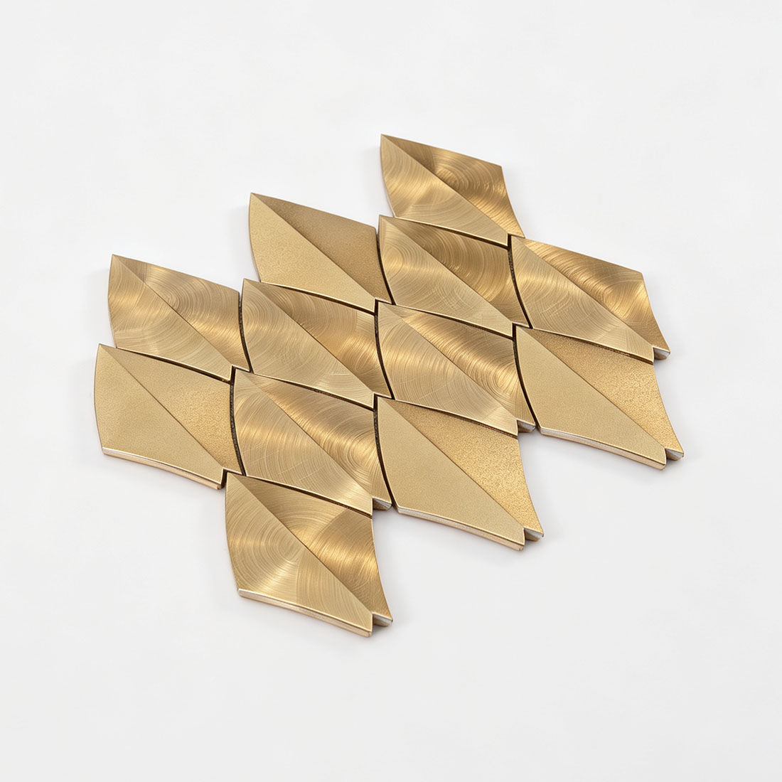 Angled view of gold feather aluminum mosaic tile sheet on a white background