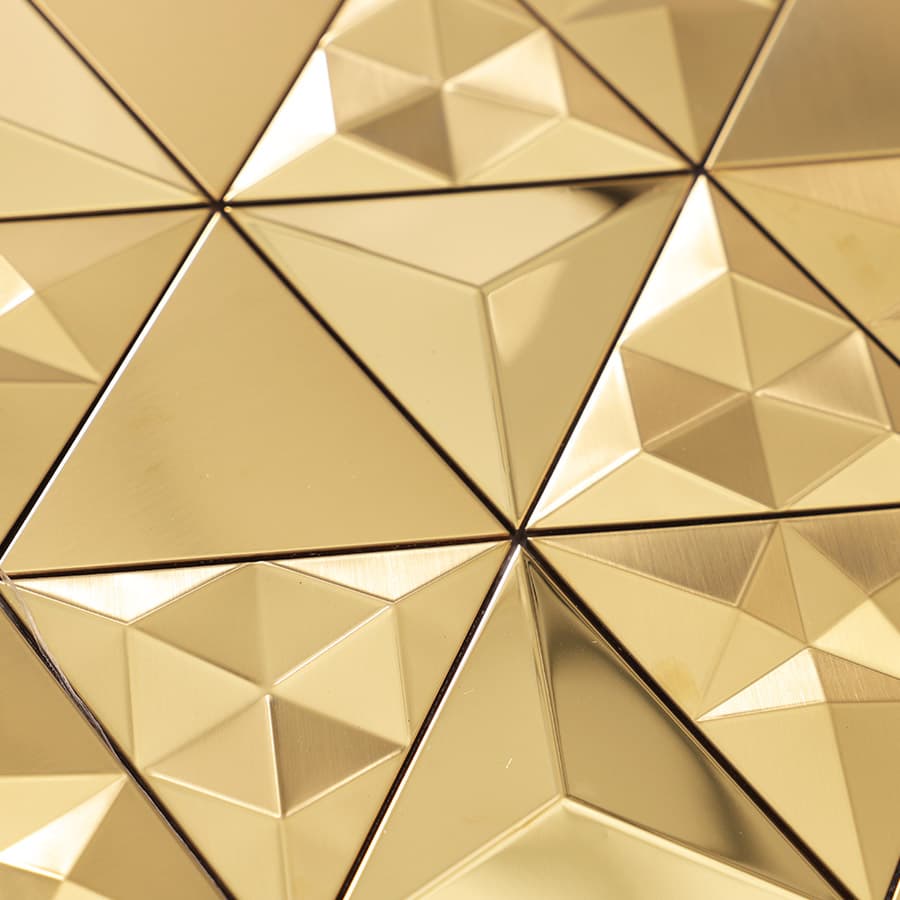  Angled macro shot of gold metal mosaic tiles with varying surface textures
