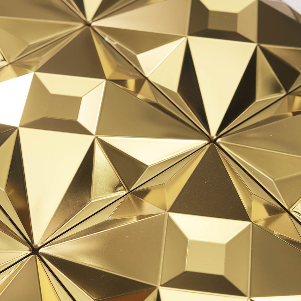 Close up of gold geometric faceted stainless steel mosaic tiles