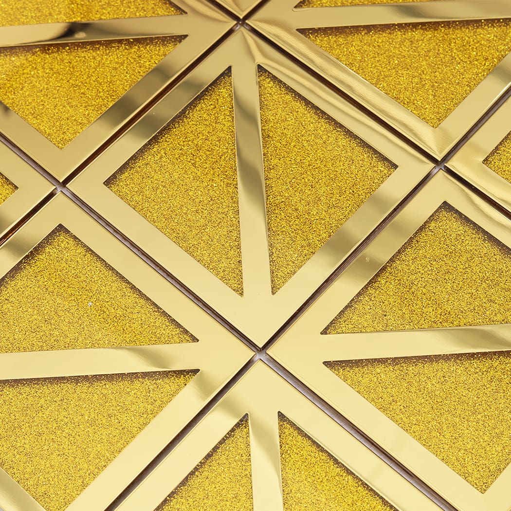 Detailed shot of the intersection of four gold geometric tiles showing glitter texture.