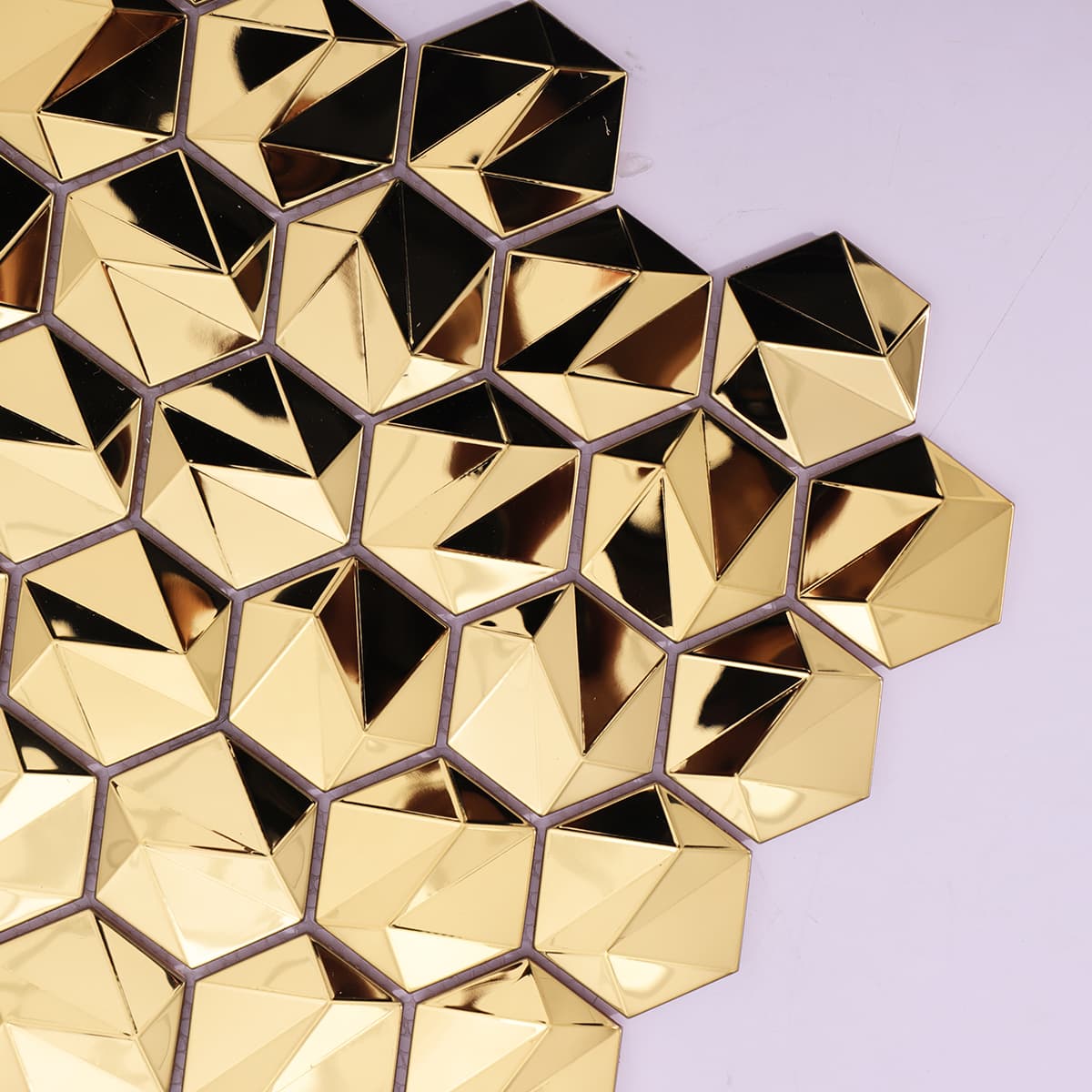Close-up shot of shiny gold stainless steel hexagon tiles
