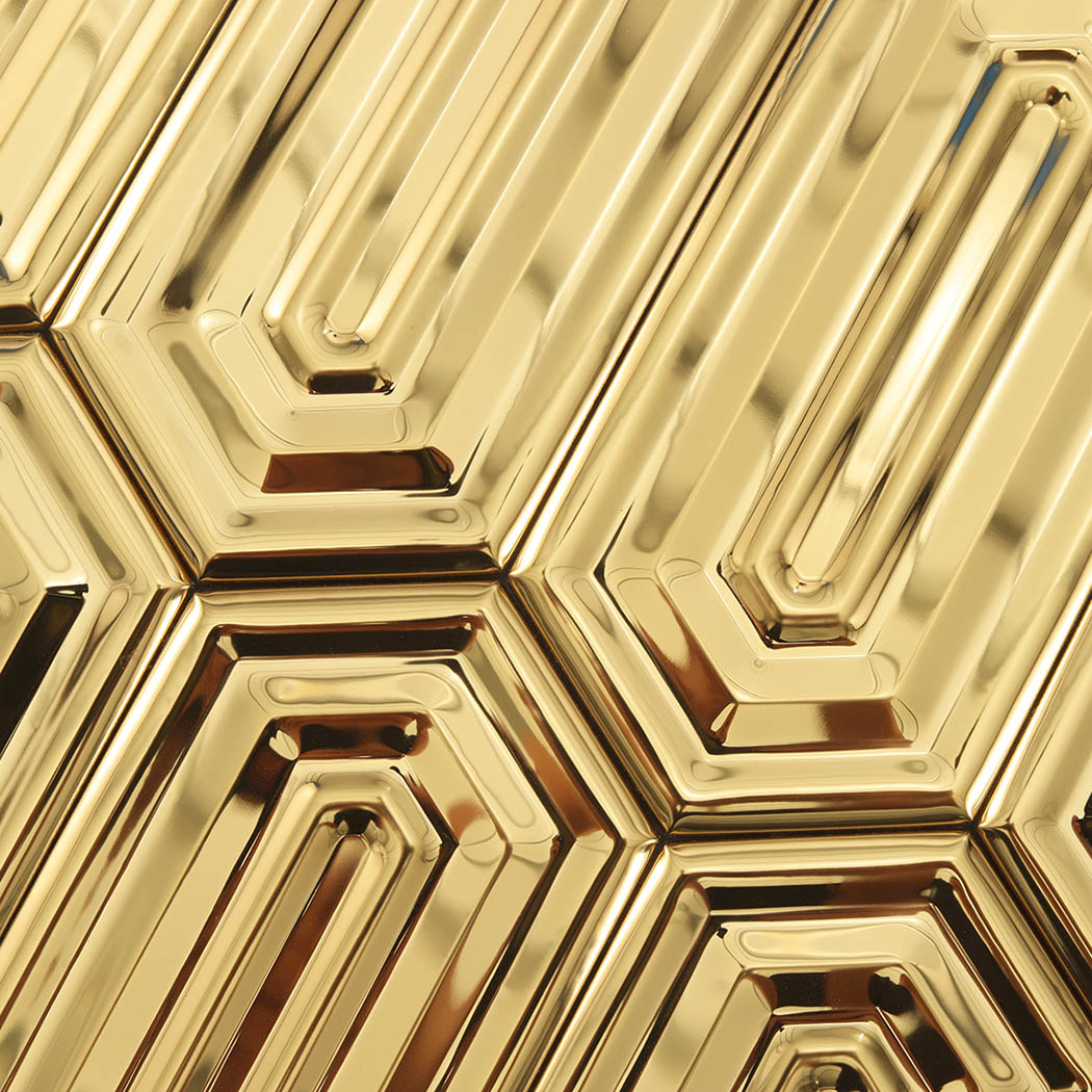 Macro view of gold hexagon metal mosaic tile pattern with geometric layering