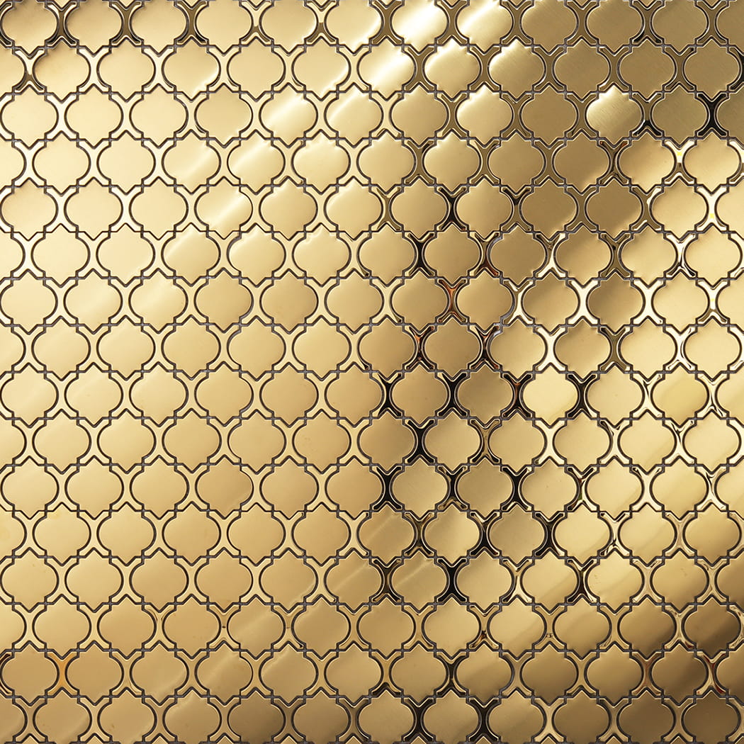 Large wall area covered in reflective gold lantern mosaic tiles.