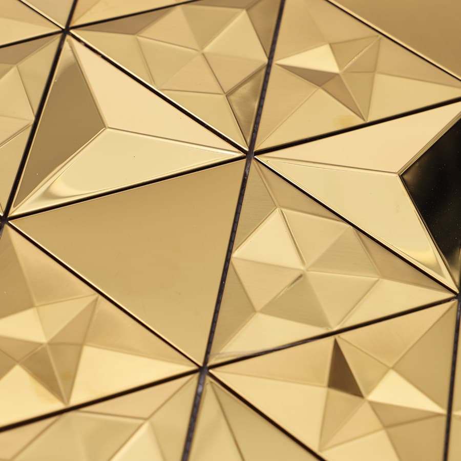 Glossy gold mosaic tiles with sharp triangular facets in a symmetrical layout.