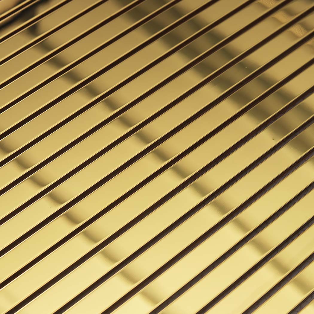 Close-up of gold mirror stainless steel ribbon tile strips