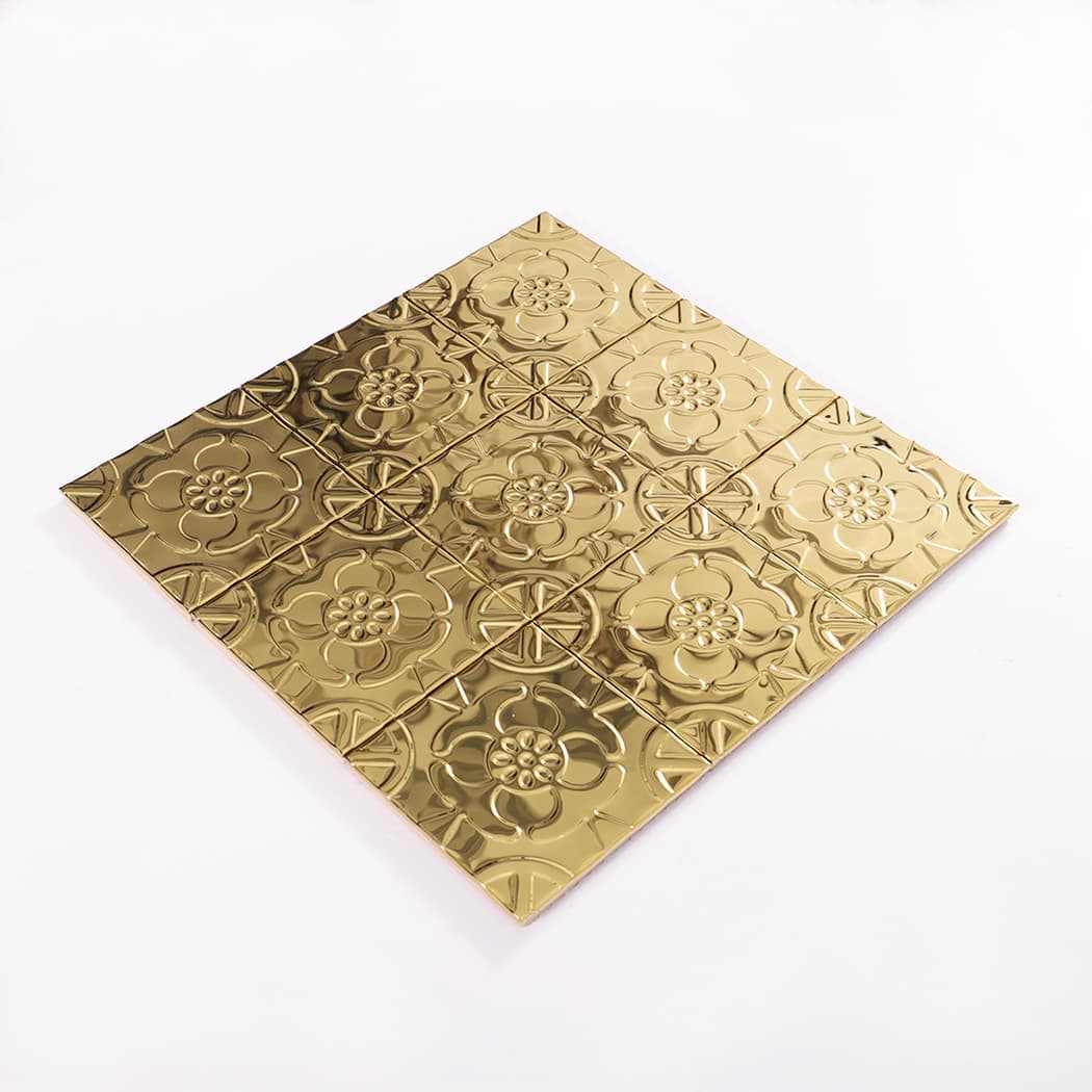 Angled product view of a gold embossed metal mosaic tile sheet on white background.