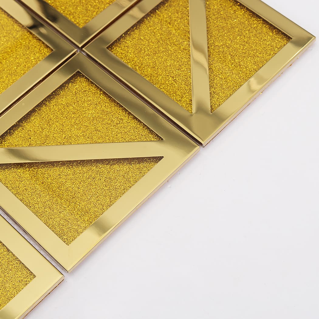 Angled view of gold mosaic tile sheet edge on a white background.