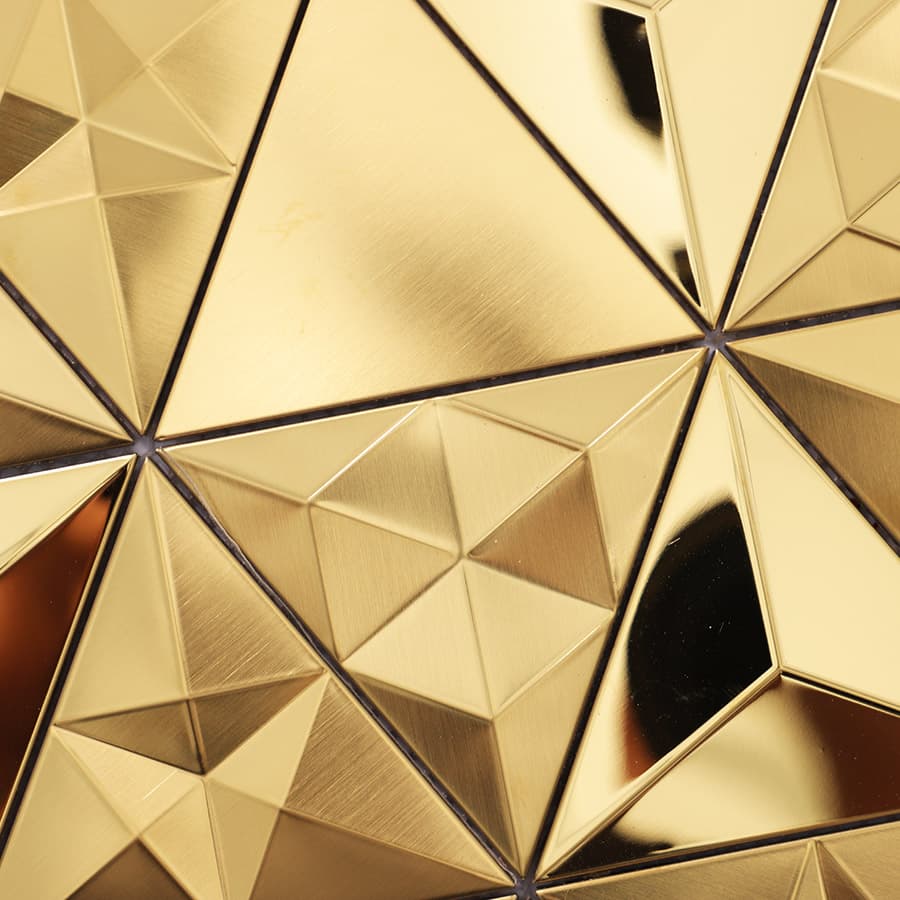 Geometric arrangement of reflective gold metal tiles with a 3D appearance.