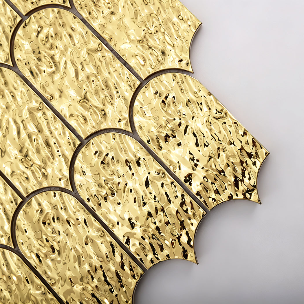 Close-up of antique gold textured scallop metal mosaic tiles