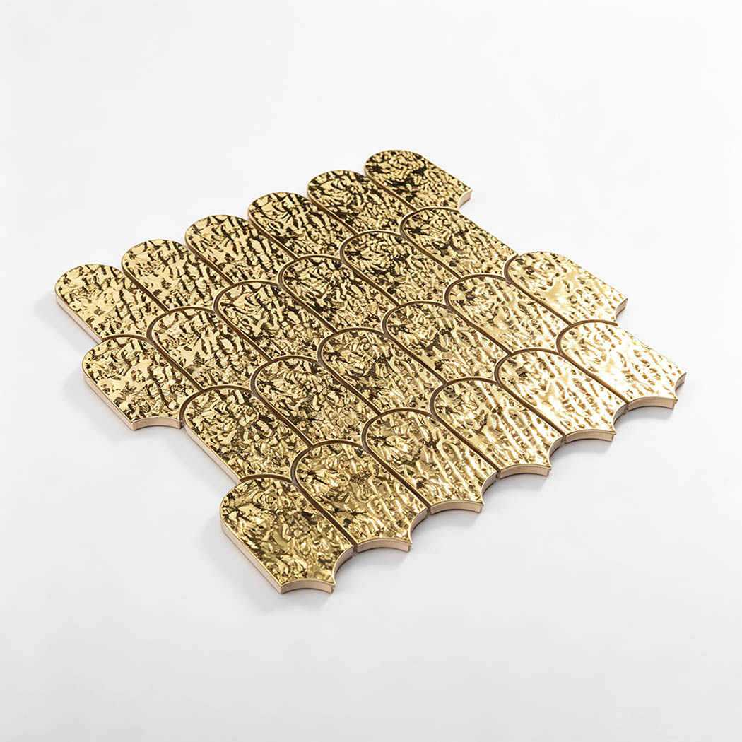 Angled view of antique gold water ripple scallop metal mosaic tile sheet