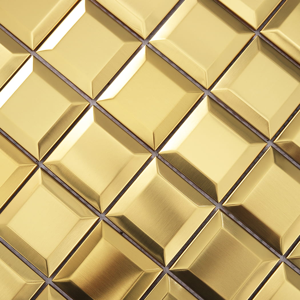 Close-up view of gold beveled metal mosaic tiles showing texture and shine