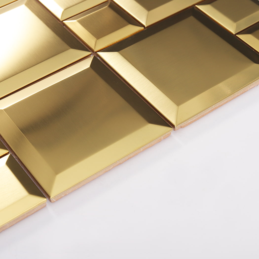 Side view of gold brushed stainless steel beveled tiles showing thickness and edges