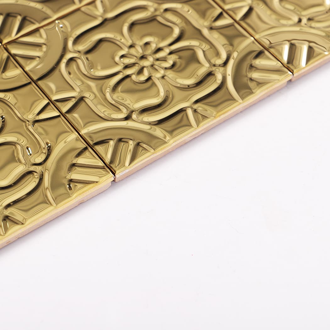 Side profile of gold embossed stainless steel mosaic tile showing edge thickness