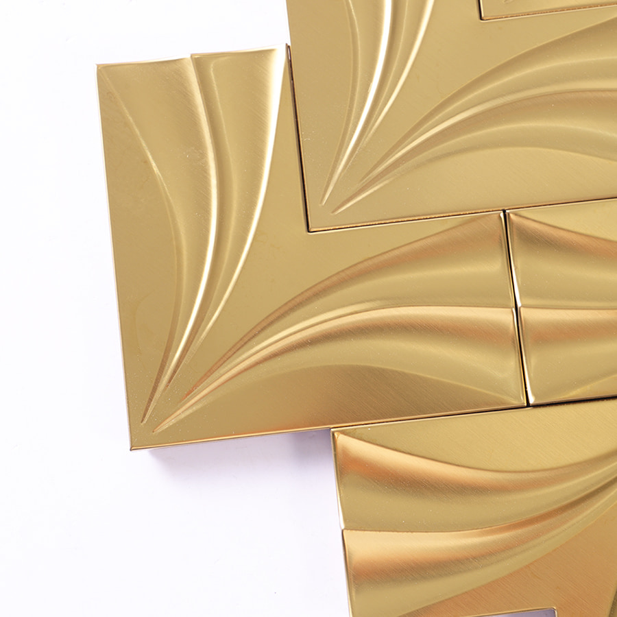 Close up detail of gold 3D herringbone metal mosaic tile corner
