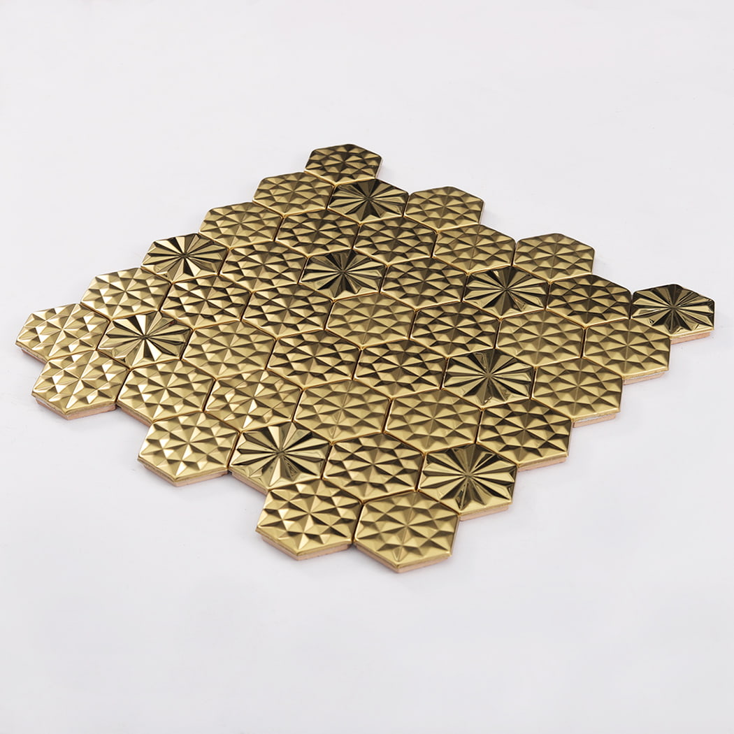Angled perspective of gold hexagon metal mosaic tile sheet on white background