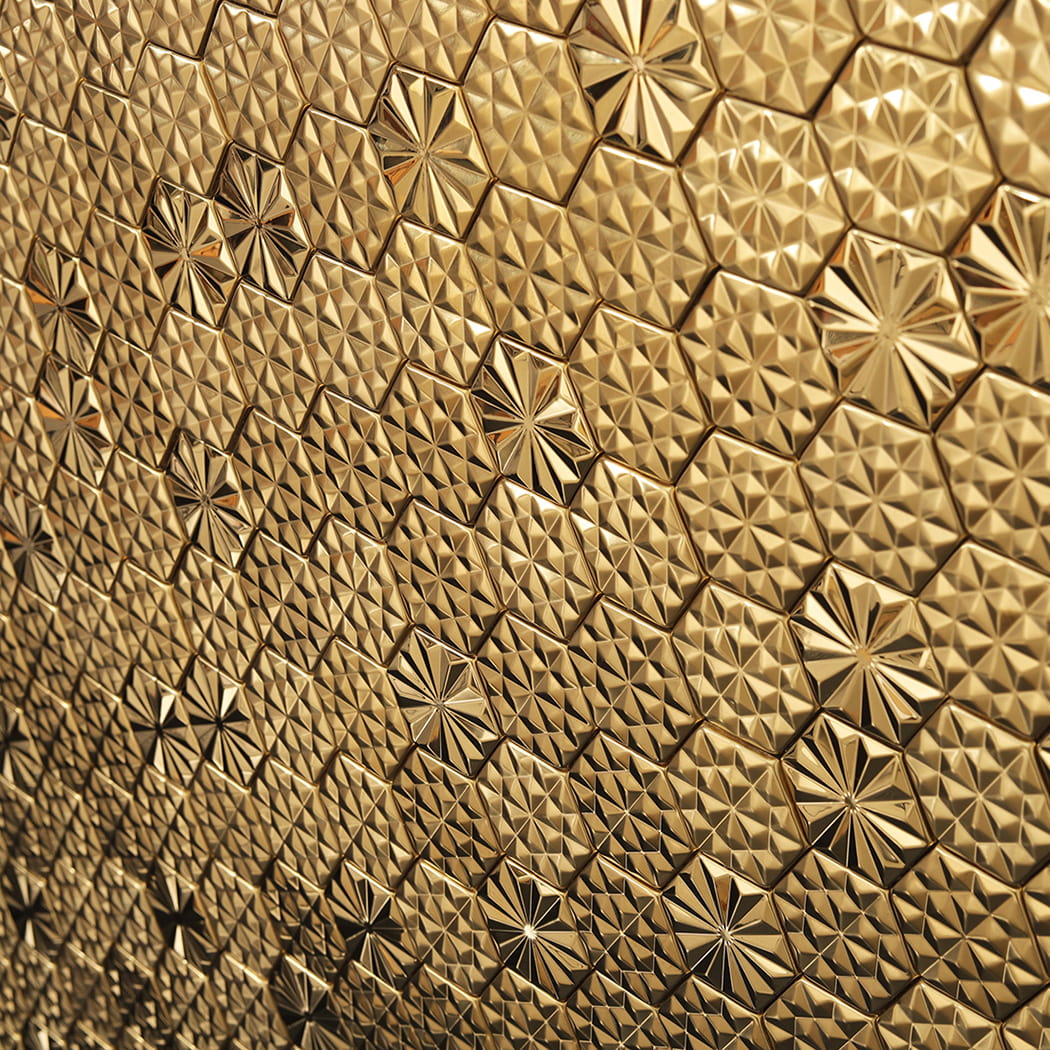 Angled view of gold hexagon metal mosaic tile wall with reflective surface