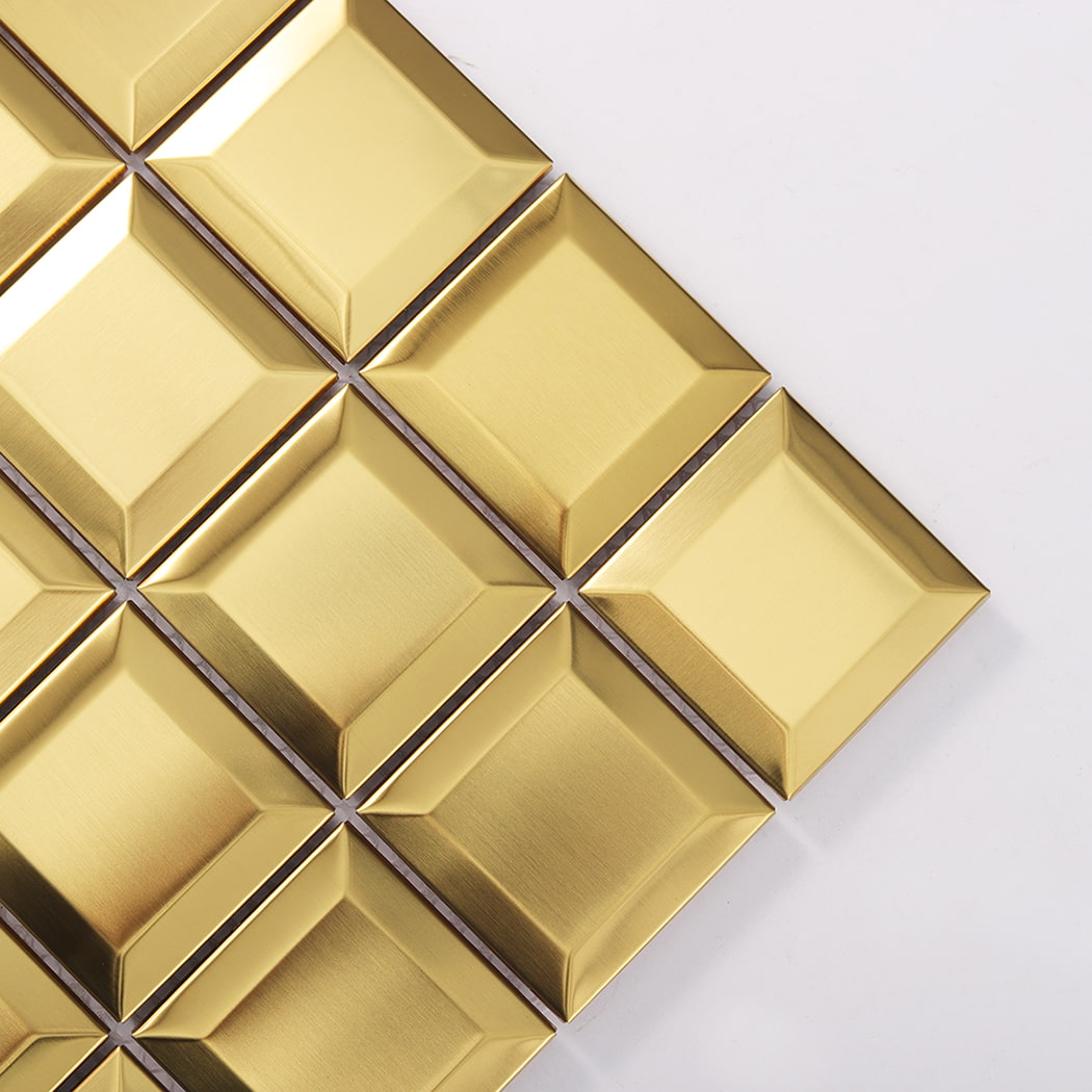 Close-up corner detail of gold metal mosaic tiles with beveled edges