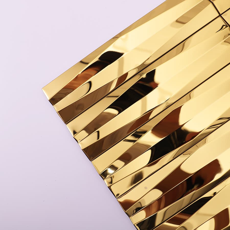 Close up of gold stainless steel 3D wave strip mosaic tile surface