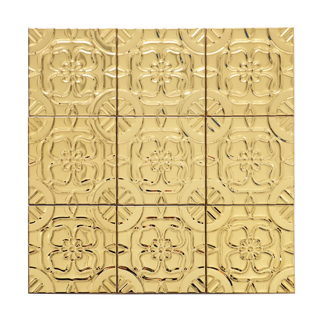 Front view of gold stainless steel square mosaic tile with raised floral pattern
