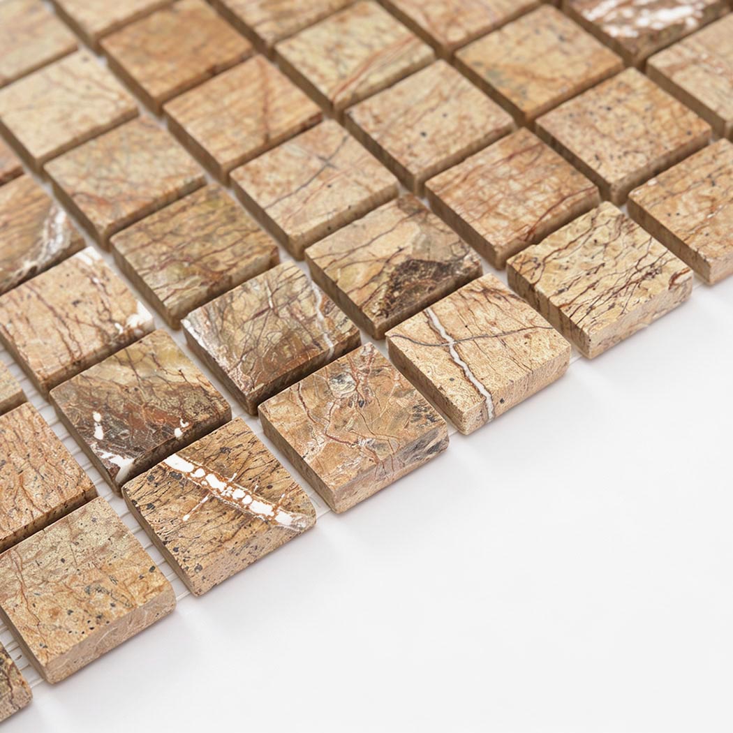 Angled view of golden brown marble square mosaic tile pieces