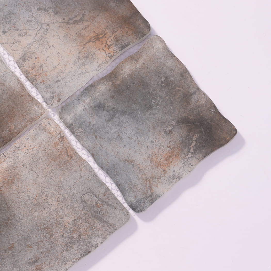 Close-up of gray brown wavy square glass mosaic tiles with mottled texture