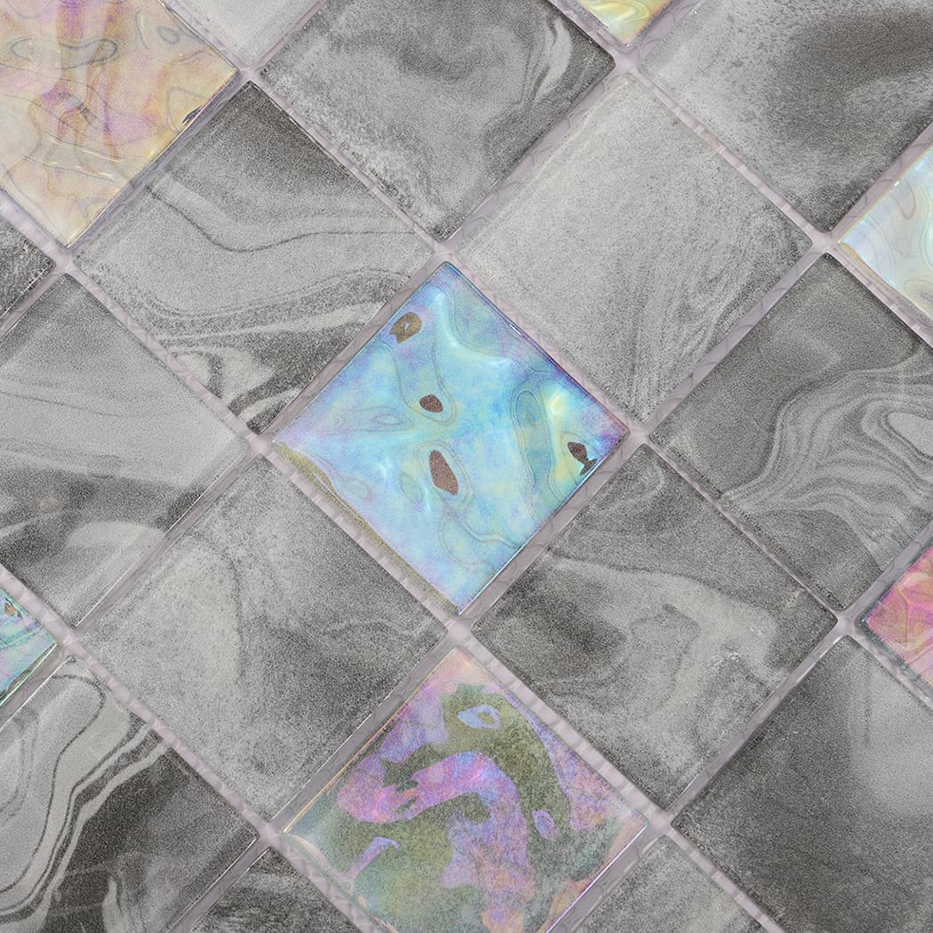 Detailed view of gray square glass mosaic with a blue iridescent accent tile