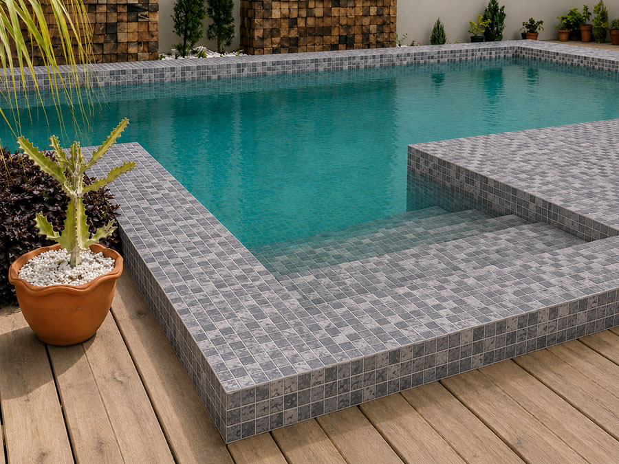 Gray mosaic poolside tiles covering steps, coping, and a modern outdoor swimming pool