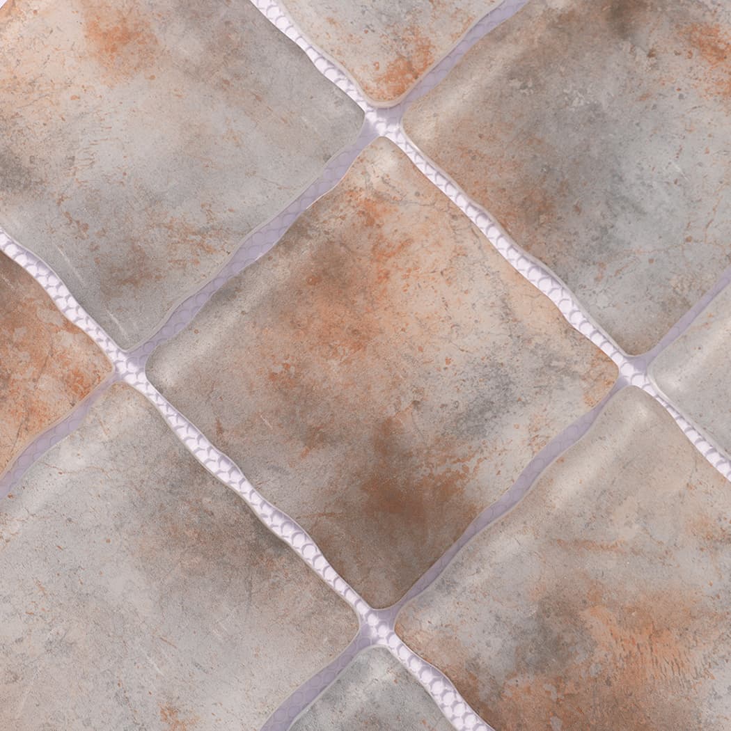 Surface detail of gray rust orange wavy square glass mosaic tiles