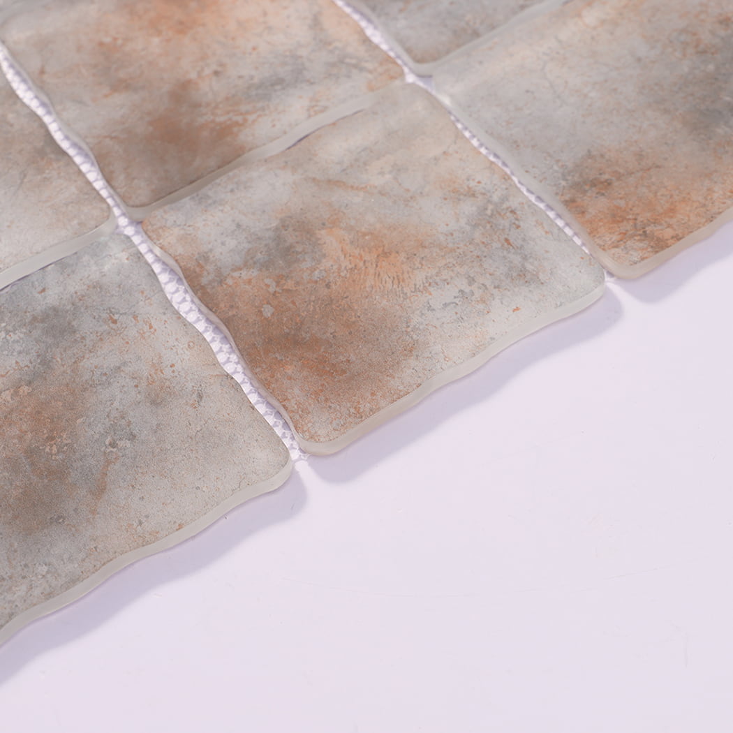 Edge detail of gray rust orange wavy square glass mosaic tiles on mesh