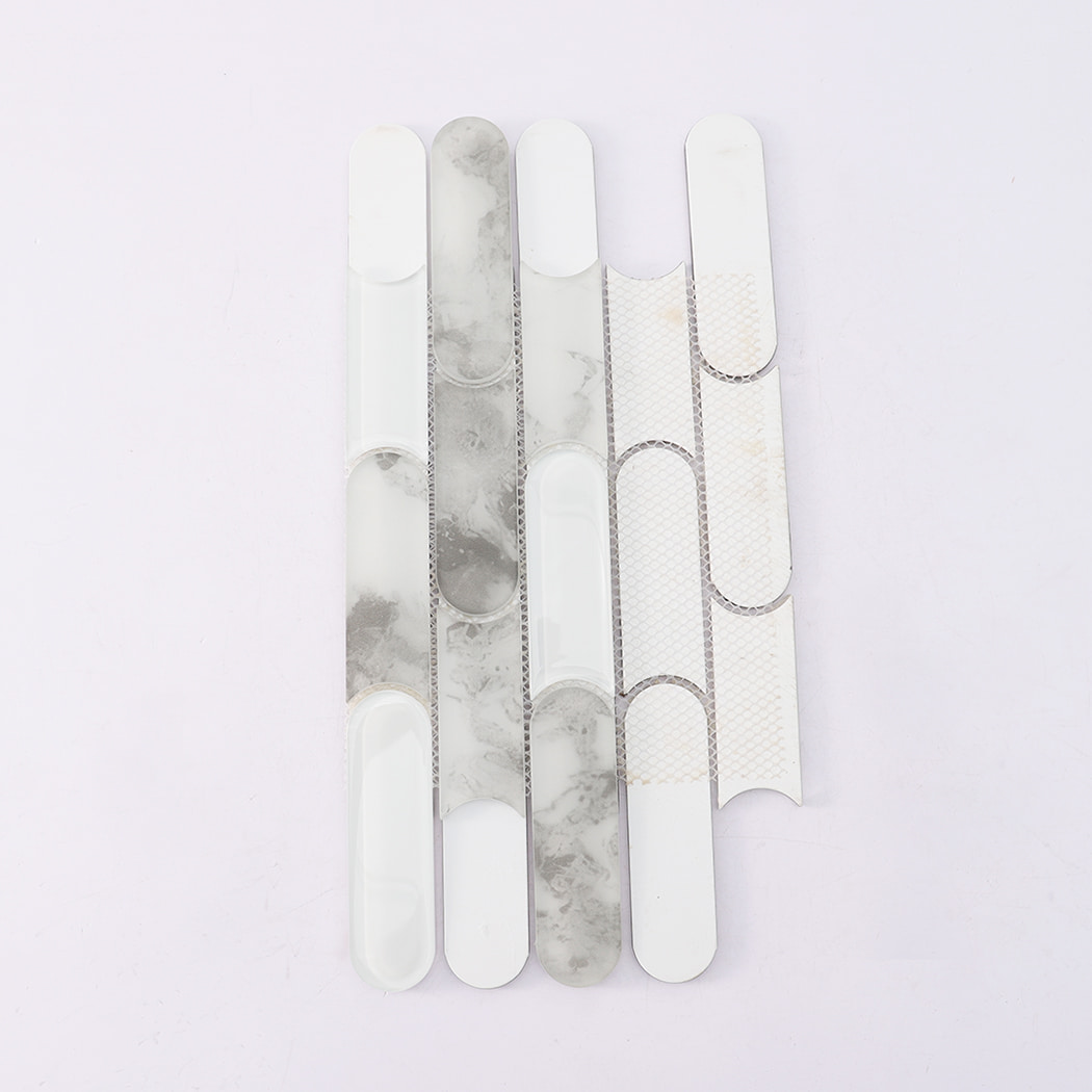 Back view of gray marble and white glass scalloped linear mosaic tile on mesh