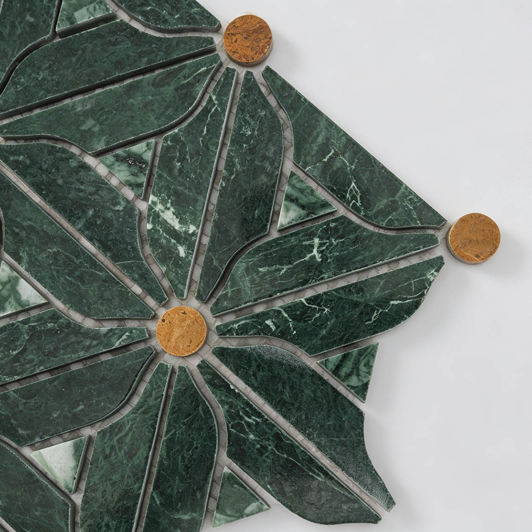Close-up of green marble floral mosaic tile with golden round accents