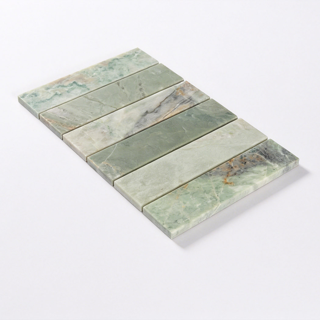 Angled view of a green marble strip tile sheet with six natural stone pieces