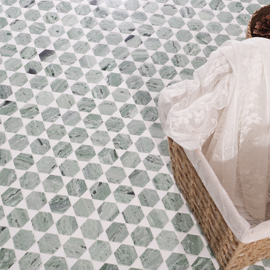 Top view of green marble mosaic floor with woven basket and white cloth