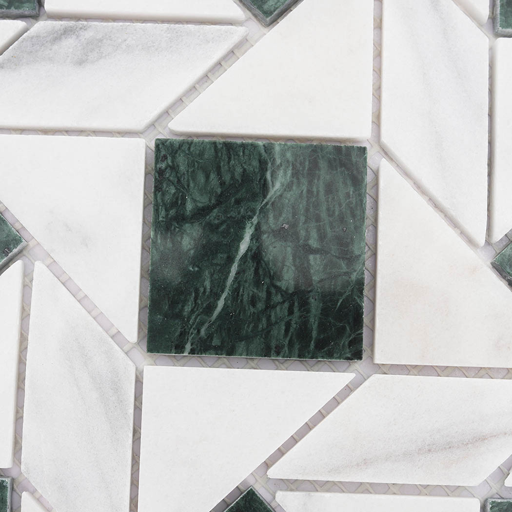 Green marble square accent surrounded by white geometric mosaic tiles