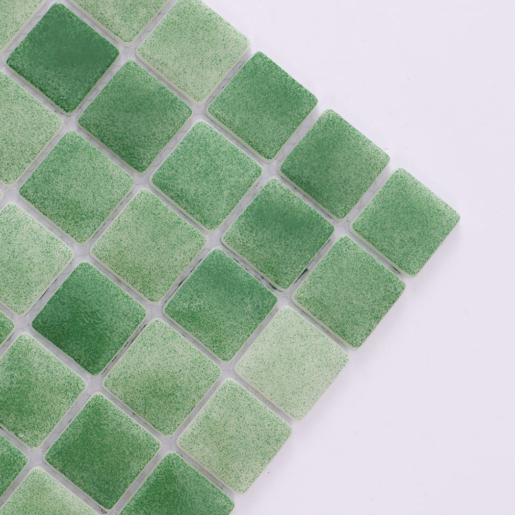 Angled close-up showing texture of green recycled glass mosaic tiles.