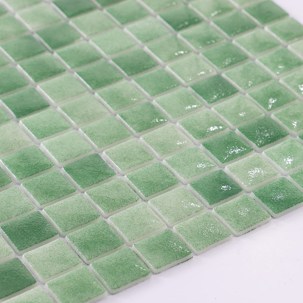 Glossy close-up of green recycled glass mosaic tiles.